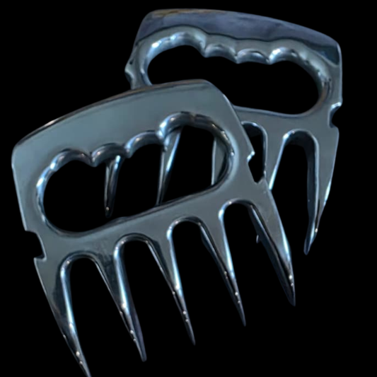 Metallic meat shredders on a black background