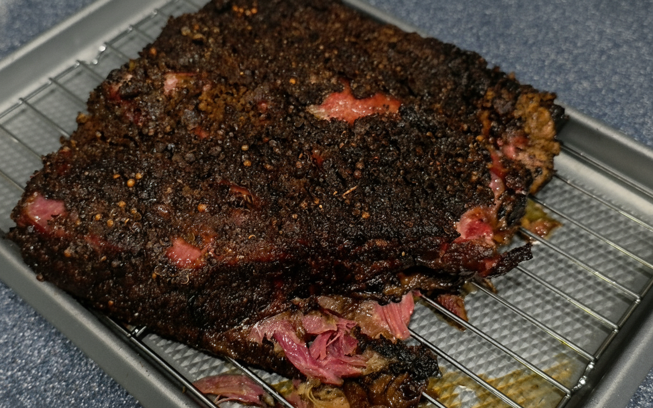 Full rack of beef rib pastrami with black pepper coriander bark on cooling rack - NY BBQ Guys smoked beef ribs recipe