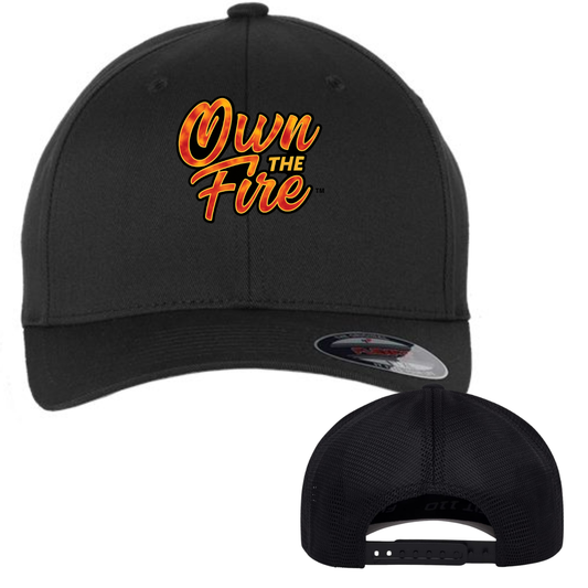 OWN THE FIRE black Flexfit snapback cap with orange and gold flame script logo on front panel, structured mid-profile with Permacurv visor