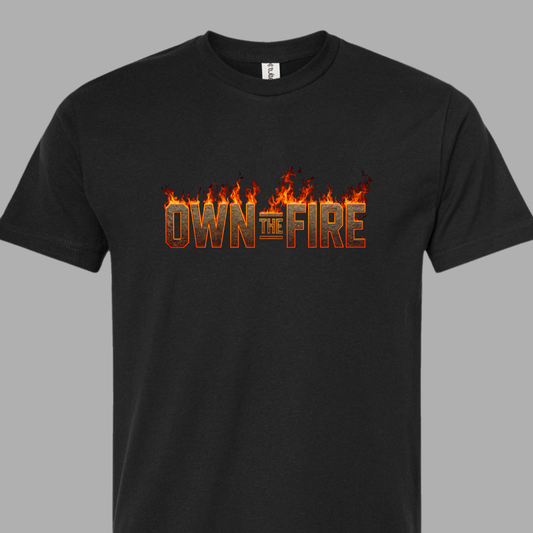 Black t-shirt with 'OWN THE FIRE' text and flames on a gray background