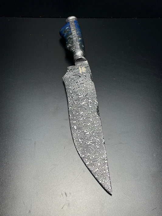 Decorative knife with an engraved blade on a dark background