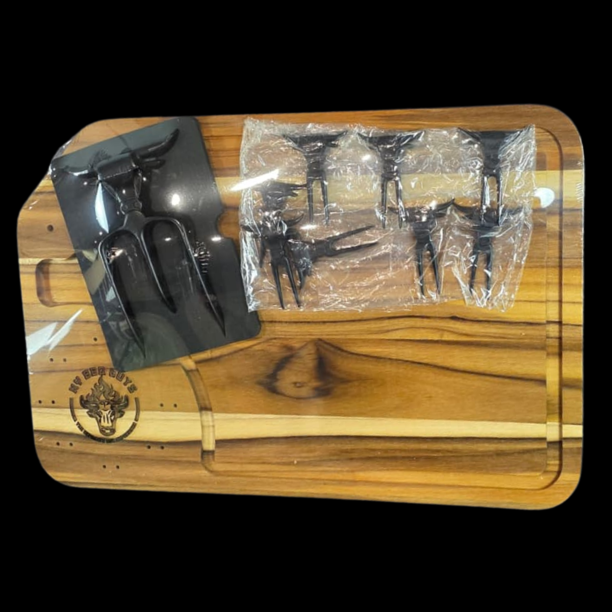 Wooden cutting board with black tools and a clear plastic bag on a black background