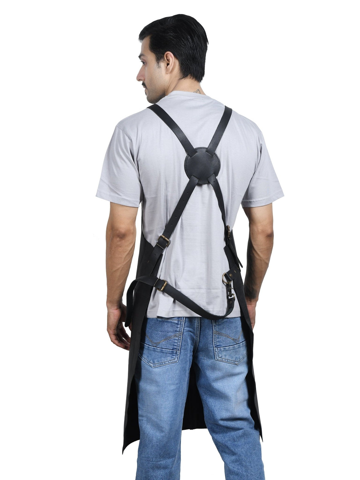 The Forge cross-back full-grain leather apron by Own The Fire, worn at a live fire