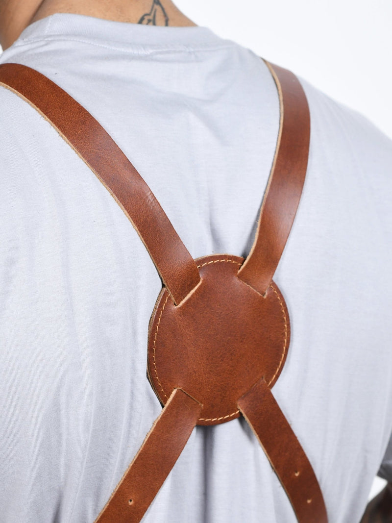 Own The Fire leather apron worn at a live fire grill