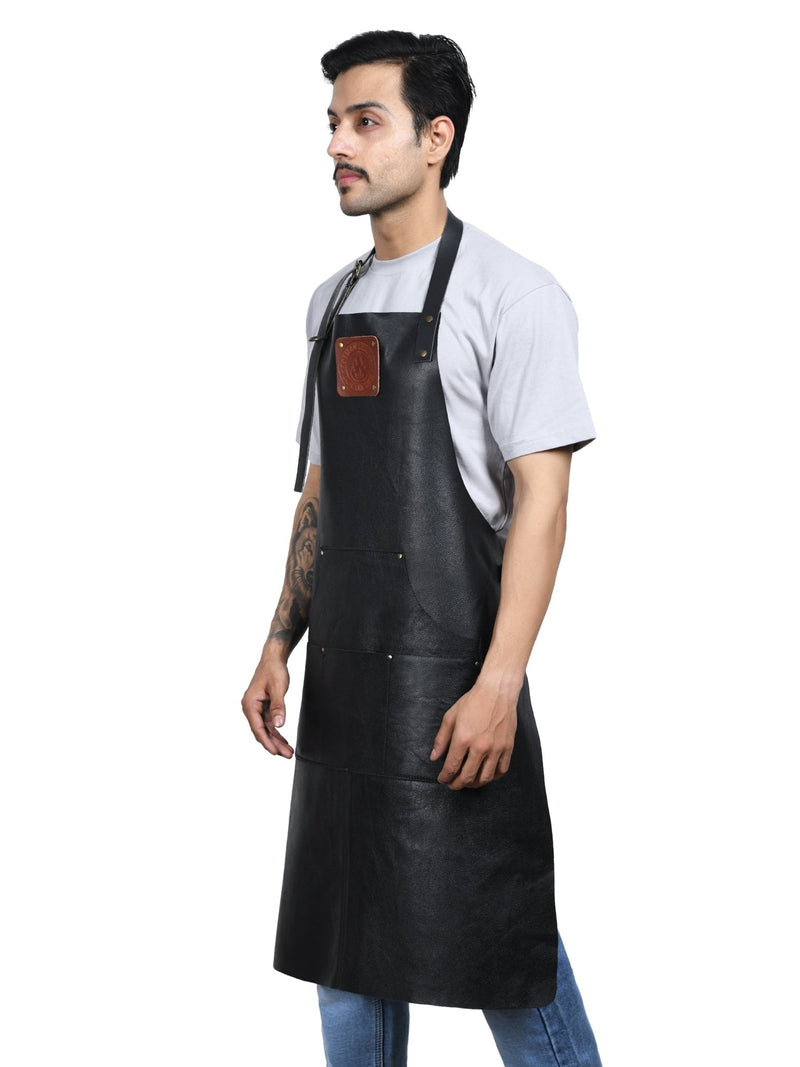 Stitching, rivets, and hardware detail on an Own The Fire leather apron