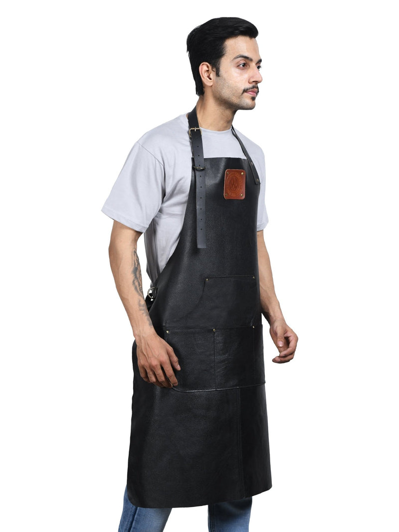 Top-grain leather texture and brass hardware detail on an Own The Fire apron